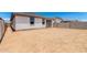 View of a backyard featuring a patio attached to a single-story home with a block wall at 17043 W Fetlock Trl, Surprise, AZ 85387