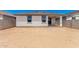 View of a backyard with a patio attached to a single-story home, surrounded by a block wall at 17043 W Fetlock Trl, Surprise, AZ 85387