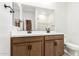 Bathroom features a double sink vanity with a large mirror and black fixtures at 17043 W Fetlock Trl, Surprise, AZ 85387
