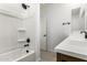 Bathroom features a shower and tub combo with black fixtures and a vanity with sink at 17043 W Fetlock Trl, Surprise, AZ 85387