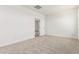Well-lit bedroom with neutral carpet and a view into the hallway and ensuite at 17043 W Fetlock Trl, Surprise, AZ 85387