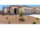 A well maintained single story home with a two car garage and desert landscaping at 17043 W Fetlock Trl, Surprise, AZ 85387