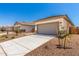 Single story home features a two-car garage, desert landscaping, and clean design at 17043 W Fetlock Trl, Surprise, AZ 85387