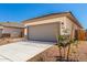 Well maintained single story home features a two-car garage and desert landscaping at 17043 W Fetlock Trl, Surprise, AZ 85387