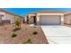 Charming single-story home features a two-car garage and desert landscaping at 17043 W Fetlock Trl, Surprise, AZ 85387