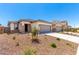 A single story home with a neutral color scheme and desert landscaping at 17043 W Fetlock Trl, Surprise, AZ 85387
