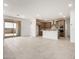 Open floor plan with neutral-toned kitchen, featuring a large island and tile flooring at 17043 W Fetlock Trl, Surprise, AZ 85387