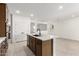 Kitchen island featuring seating space, cabinets, and stainless steel appliances in an open concept kitchen at 17043 W Fetlock Trl, Surprise, AZ 85387
