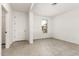 Bright living room showcases a neutral color palette and tile flooring at 17043 W Fetlock Trl, Surprise, AZ 85387