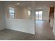 Open floor plan with tile flooring and lots of natural light from the sliding glass doors at 17043 W Fetlock Trl, Surprise, AZ 85387