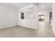 Spacious living room features an open layout and tile flooring throughout at 17043 W Fetlock Trl, Surprise, AZ 85387