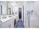 Modern bathroom with double vanity, glass-enclosed shower, and contemporary fixtures, offering a spa-like experience at 17244 W West Wind Dr, Surprise, AZ 85387