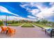 Bocce ball courts with manicured green turf, lounge chairs, string lights, and a furnished social table at 17244 W West Wind Dr, Surprise, AZ 85387