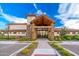Welcoming clubhouse entrance featuring stone accents, timber framing, and well-maintained landscaping at 17244 W West Wind Dr, Surprise, AZ 85387