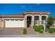 Charming single-story home featuring a terracotta tile roof, arched entryway, and brick paver walkway at 17244 W West Wind Dr, Surprise, AZ 85387