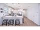 Bright kitchen with white cabinets, stainless steel appliances, and a quartz countertop island with seating at 17244 W West Wind Dr, Surprise, AZ 85387
