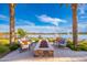 Scenic outdoor seating with a fire pit, lake views, and comfortable furnishings at 17244 W West Wind Dr, Surprise, AZ 85387
