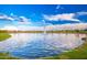 Picturesque pond featuring a fountain, tranquil water, and neatly manicured green lawns, reflecting the blue sky at 17244 W West Wind Dr, Surprise, AZ 85387