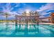 Inviting pool with palm trees, lounge chairs, umbrellas and poolside shade at 17244 W West Wind Dr, Surprise, AZ 85387