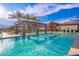 Resort-style pool featuring lounge chairs, umbrellas, and poolside cabanas for relaxation at 17244 W West Wind Dr, Surprise, AZ 85387