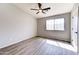 Comfortable bedroom featuring wood-look flooring, a ceiling fan, and ample natural light at 1961 N Hartford St # 1149, Chandler, AZ 85225