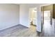 Well-lit bedroom with neutral walls, wood-look flooring, and a view to the bathroom at 1961 N Hartford St # 1149, Chandler, AZ 85225