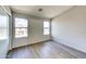 Bright bedroom featuring wood-look flooring, neutral walls, and dual windows at 1961 N Hartford St # 1149, Chandler, AZ 85225