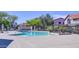 Community pool with a landscaped area and community buildings in the background at 1961 N Hartford St # 1149, Chandler, AZ 85225