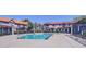 Community pool surrounded by a fence and townhome buildings at 1961 N Hartford St # 1149, Chandler, AZ 85225