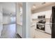 Open kitchen with sleek white cabinetry and stainless steel appliances, perfect for cooking and entertaining at 1961 N Hartford St # 1149, Chandler, AZ 85225
