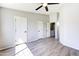 Bright main bedroom featuring wood-look floors, neutral walls, and three closet doors at 1961 N Hartford St # 1149, Chandler, AZ 85225