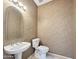 Traditional bathroom with pedestal sink, large mirror, and neutral color scheme at 19982 N Tealstone Dr, Surprise, AZ 85374