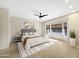 Stylish bedroom with large window and natural light, plush carpet, and geometrically patterned rug at 19982 N Tealstone Dr, Surprise, AZ 85374