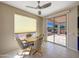 Cozy breakfast nook with tile flooring, ceiling fan, and sliding door access to the patio at 19982 N Tealstone Dr, Surprise, AZ 85374