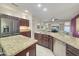 Open kitchen featuring a stainless refrigerator and large center island with sink at 19982 N Tealstone Dr, Surprise, AZ 85374