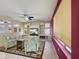 Bright living room with a ceiling fan, a built-in shelving unit, and a large window at 19982 N Tealstone Dr, Surprise, AZ 85374