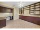 Home office with dark wood built-ins, ample cabinetry, and tile flooring at 19982 N Tealstone Dr, Surprise, AZ 85374