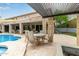 Backyard pool and patio with stone columns and a covered pergola for seating at 2024 E Taurus Pl, Chandler, AZ 85249