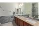 Bathroom with double sinks, light fixtures, mirrors, and stylish vanity at 2024 E Taurus Pl, Chandler, AZ 85249