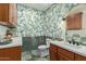 Charming bathroom with tropical wallpaper, wood cabinetry, and tile flooring at 2024 E Taurus Pl, Chandler, AZ 85249