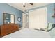 Bedroom with blue walls, dresser, comfortable chair and white closet doors at 2024 E Taurus Pl, Chandler, AZ 85249