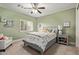 Charming bedroom with a ceiling fan, plush carpet, and bright green walls at 2024 E Taurus Pl, Chandler, AZ 85249