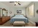 Comfortable bedroom with neutral carpet, a ceiling fan, and blue accents at 2024 E Taurus Pl, Chandler, AZ 85249