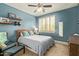Cozy bedroom with blue walls, ceiling fan, window with shutters, and carpet at 2024 E Taurus Pl, Chandler, AZ 85249