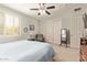 Bright bedroom features soft carpet, a ceiling fan, and ample storage space at 2024 E Taurus Pl, Chandler, AZ 85249