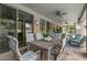 Relaxing covered patio with ceiling fans, dining table, and comfortable seating area at 2024 E Taurus Pl, Chandler, AZ 85249