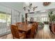 Open-concept dining room featuring a long wood table, natural light, and wood flooring at 2024 E Taurus Pl, Chandler, AZ 85249