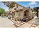 Back view of the home exterior with yard and utility area, set on gravel and decorative stones at 2024 E Taurus Pl, Chandler, AZ 85249