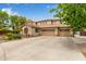 Beige two-story home featuring a wide driveway and three-car garage at 2024 E Taurus Pl, Chandler, AZ 85249