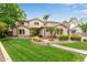 Expansive home with manicured front lawn, mature palms, and neutral color scheme at 2024 E Taurus Pl, Chandler, AZ 85249